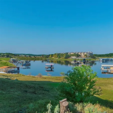 a view of a lake with houses in the back