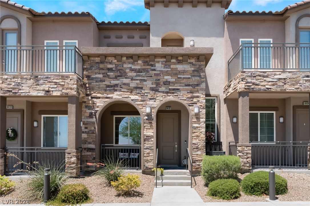 6432 Spring Jog Street Las Vegas, NV 89166 - Photo 2 of 61 A contemporary townhouse with stacked stone accents and private balconies welcomes you home.