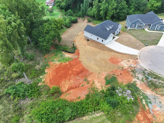 an aerial view of a house with yard and lake view