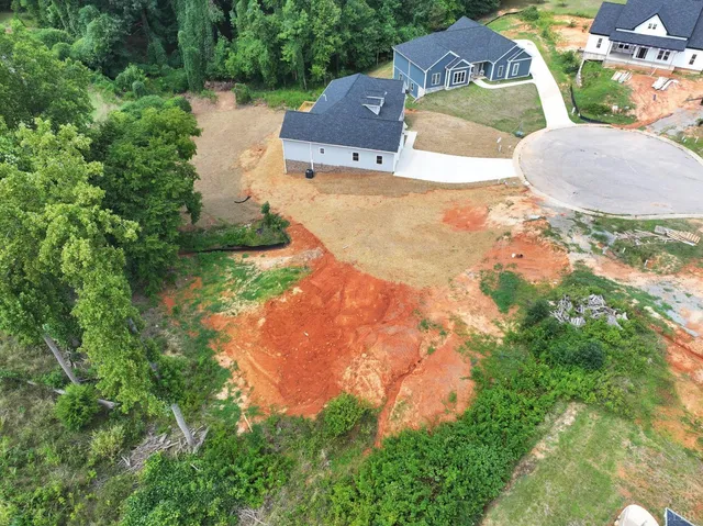 an aerial view of a house with yard