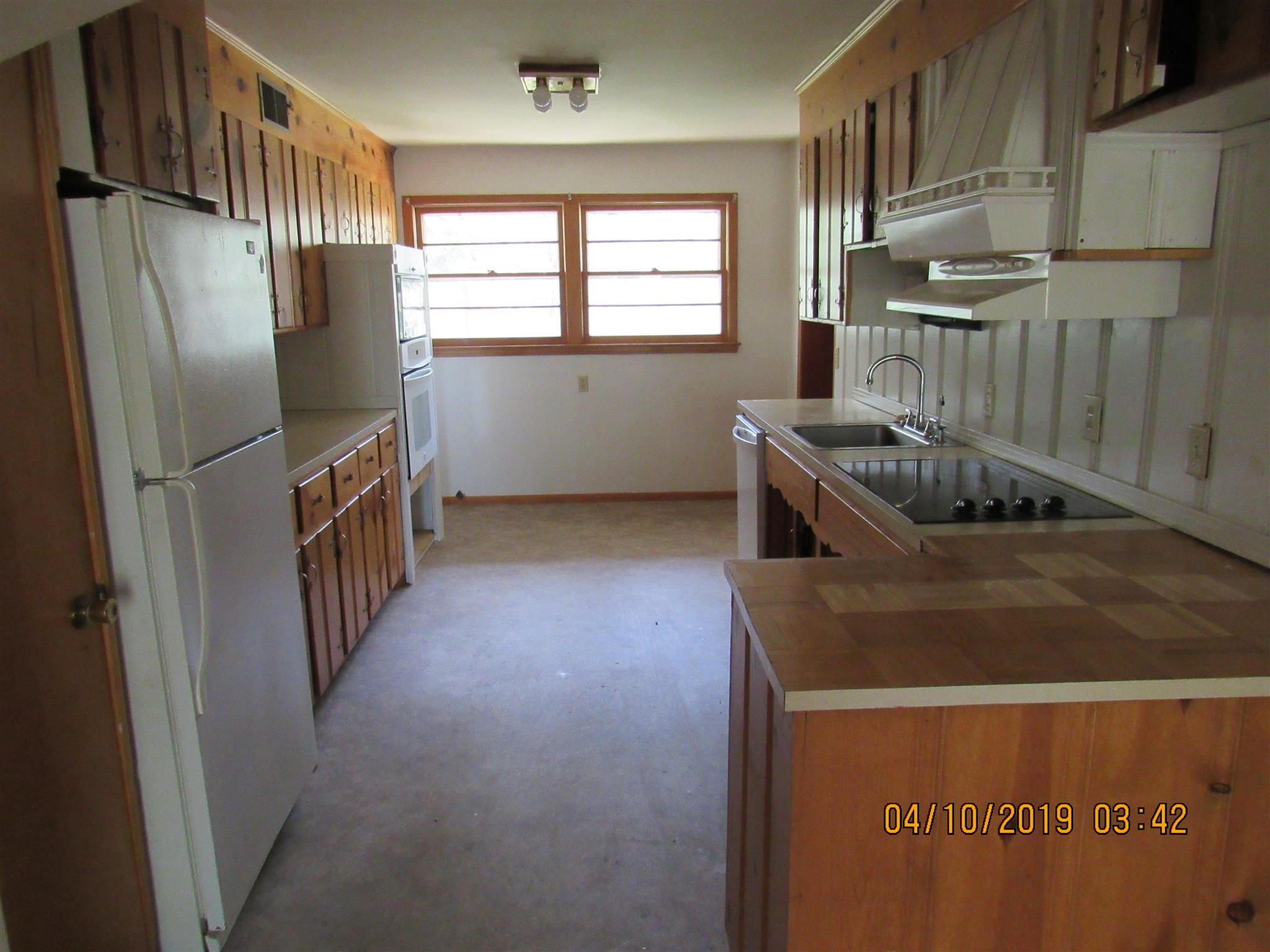 244 Pine Thicket Road McEwen, TN 37101 - Photo 12 of 26 a kitchen with a refrigerator and window