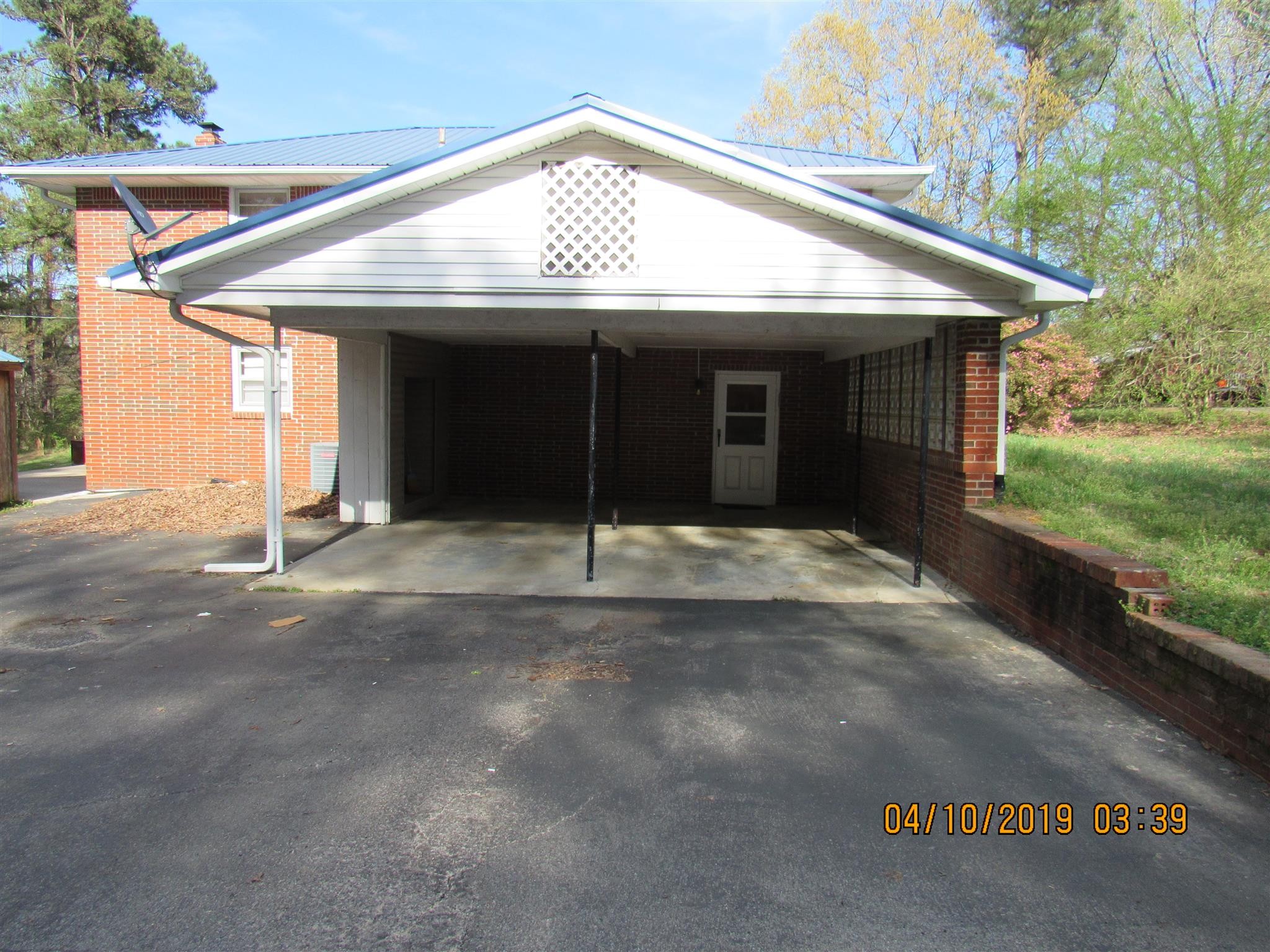 244 Pine Thicket Road McEwen, TN 37101 - Photo 4 of 26 a view of a white house with a yard and garage