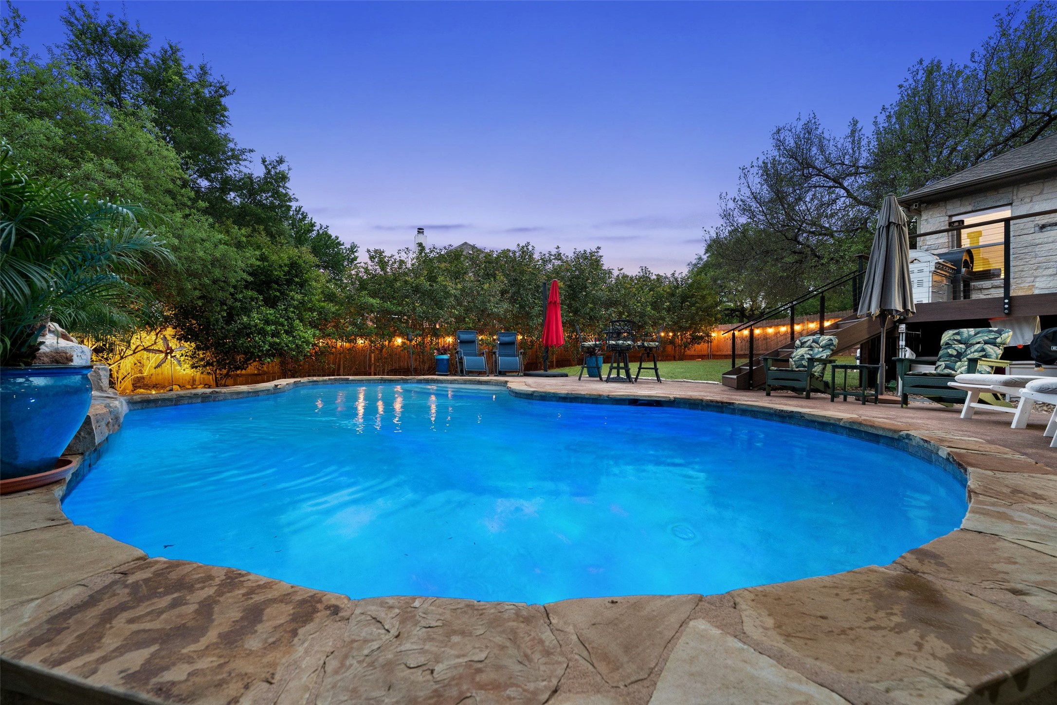 15208 Nightingale Lane Austin, TX 78734 - Photo 2 of 40 Pool at dusk featuring an outdoor pool and a patio