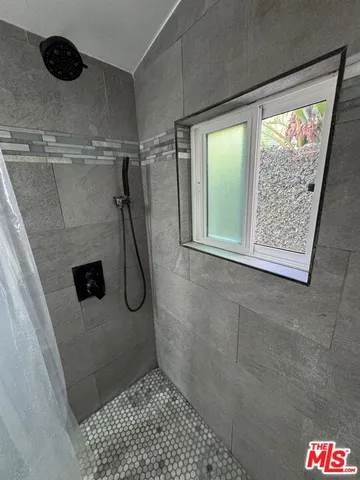 a bathroom with a glass shower door