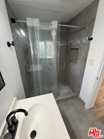 a bathroom with a shower and toilet