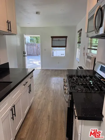 a kitchen with granite countertop a stove and a sink