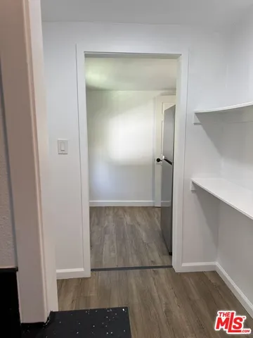 an entryway door with wooden floor