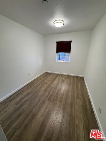 a view of an empty room and wooden floor