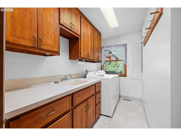 a kitchen with a sink cabinets and window