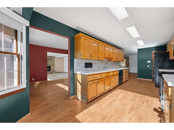 a kitchen with stainless steel appliances granite countertop a stove and cabinets