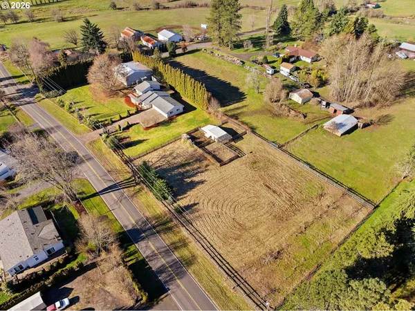 an aerial view of a houses with a swimming pool