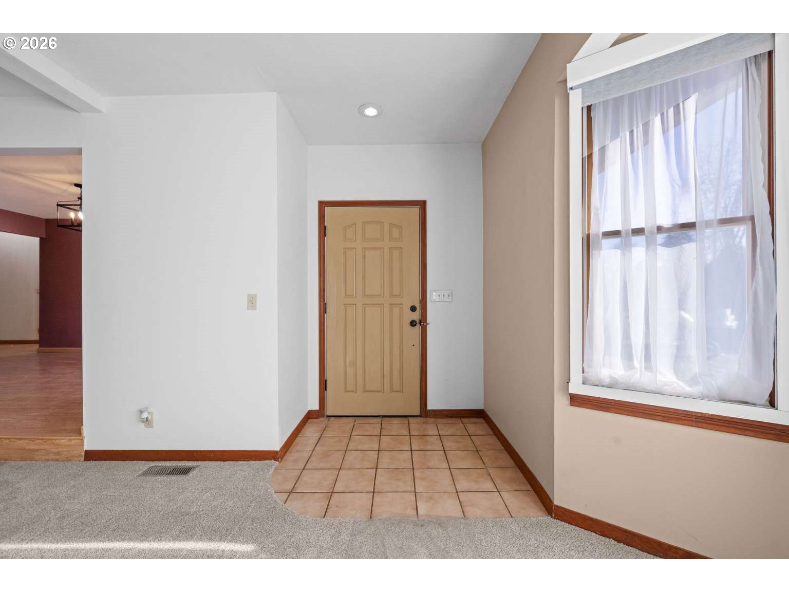 33887 Church Road Warren, OR 97053 - Photo 8 of 35 a view of an empty room with wooden floor and a window