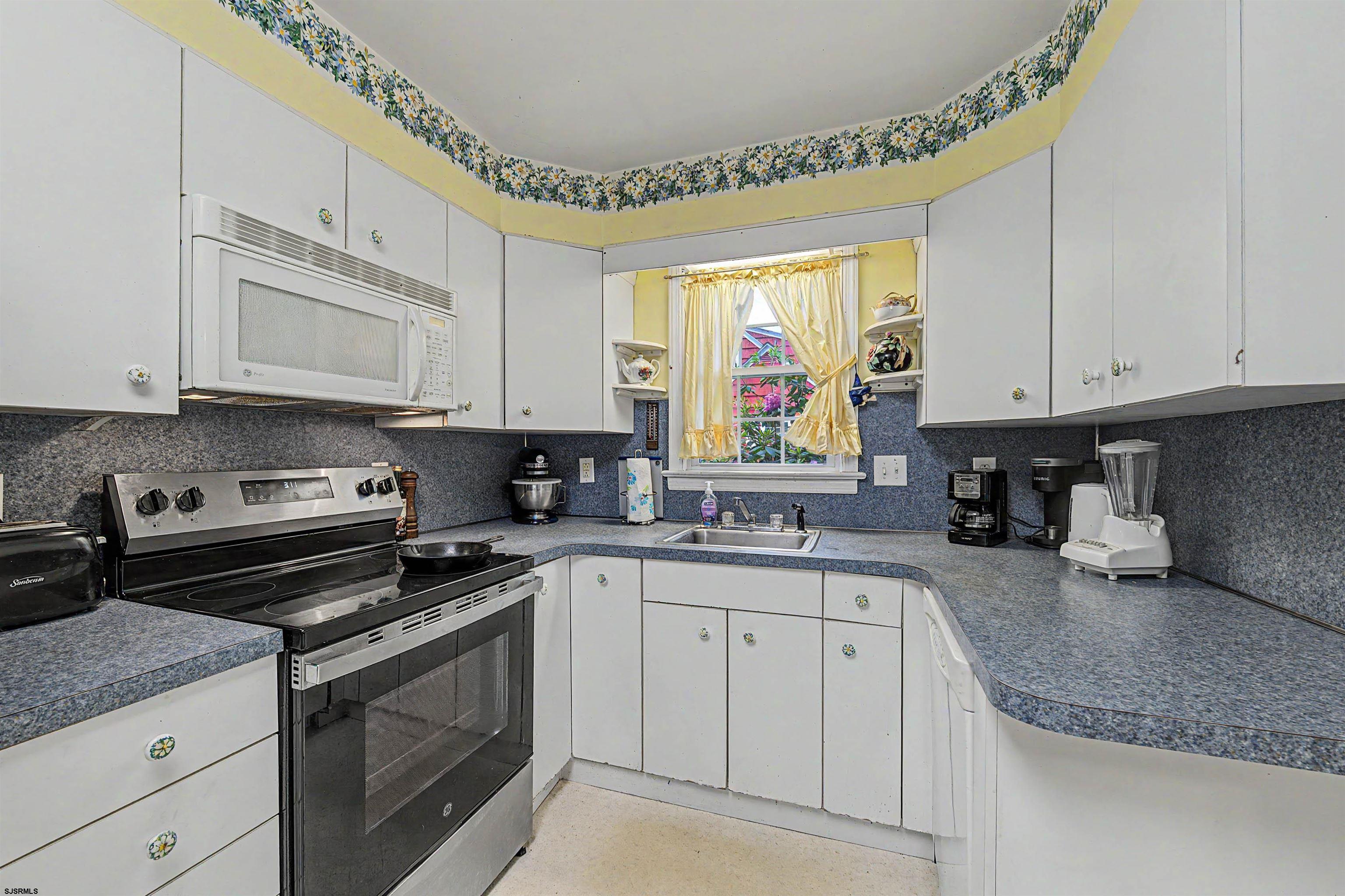 144 Pitney Road Absecon, NJ 08201 - Photo 22 of 47 a kitchen with granite countertop a sink a stove and cabinets
