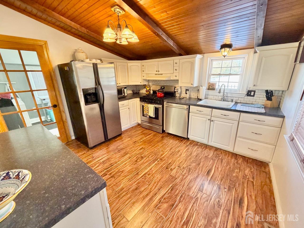623-623 Main Street Leesburg, NJ 08327 - Photo 26 of 66 a kitchen with granite countertop a refrigerator a sink dishwasher a stove and white countertops with wooden floor