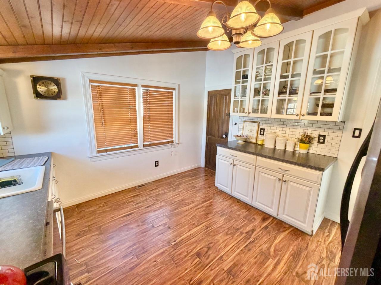 623-623 Main Street Leesburg, NJ 08327 - Photo 30 of 66 a large white kitchen with cabinets a sink a window and a wooden floor