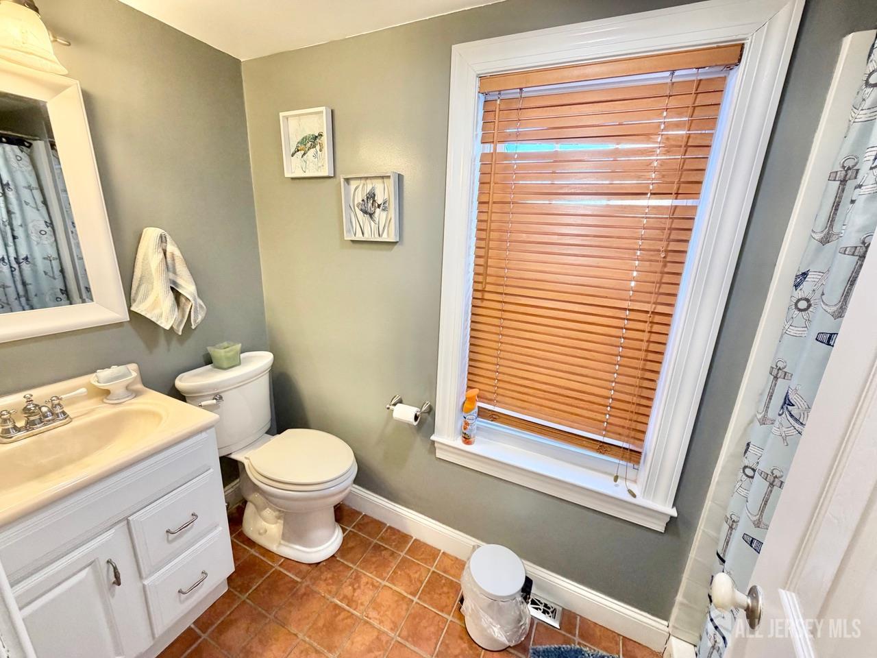 623-623 Main Street Leesburg, NJ 08327 - Photo 38 of 66 a bathroom with a toilet sink and a window