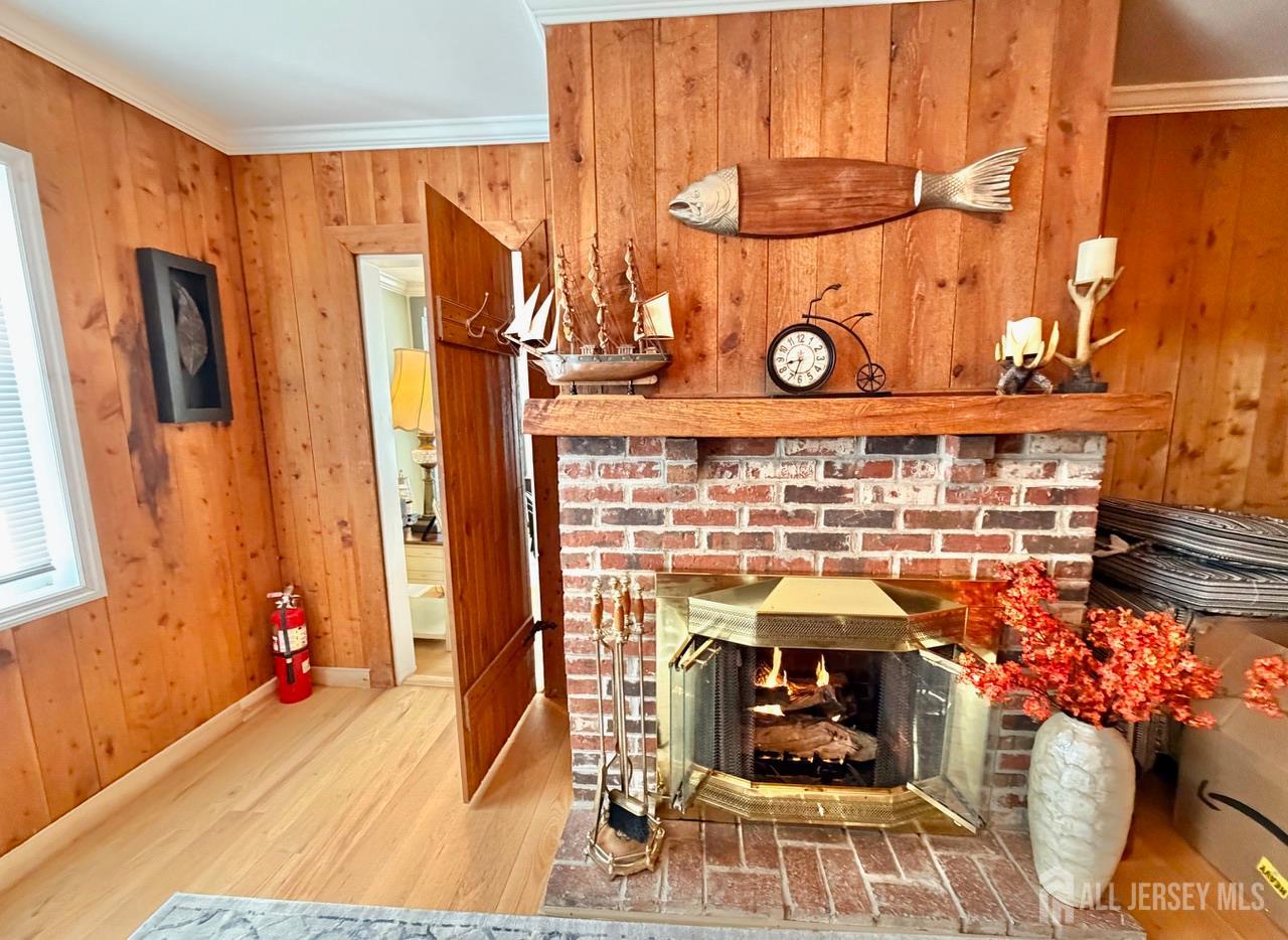 623-623 Main Street Leesburg, NJ 08327 - Photo 43 of 66 a living room with a fireplace and wooden floor