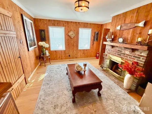 a living room with furniture and a dresser