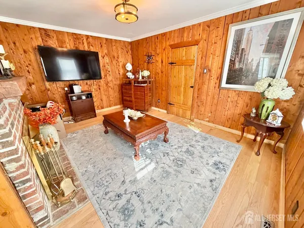 a view of a bedroom with wooden floor and staircase