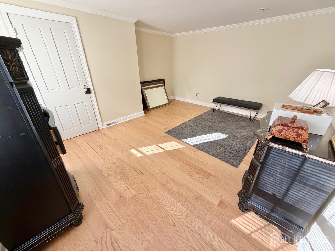 623-623 Main Street Leesburg, NJ 08327 - Photo 62 of 66 a view of a bedroom with wooden floor and staircase