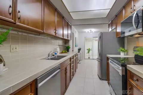 a kitchen with stainless steel appliances a sink stove and cabinets