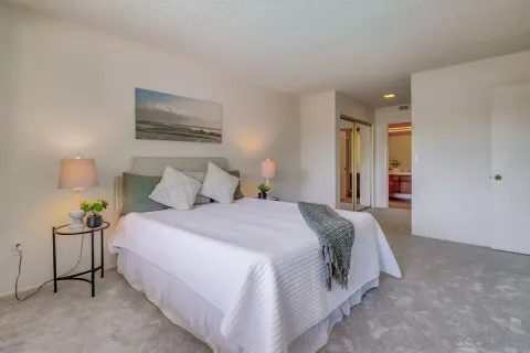 a bedroom with a bed and a lamp