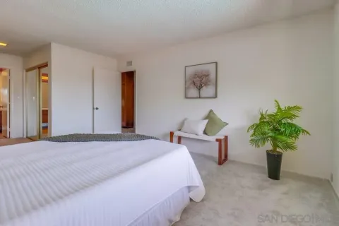 a bedroom with furniture and a potted plant