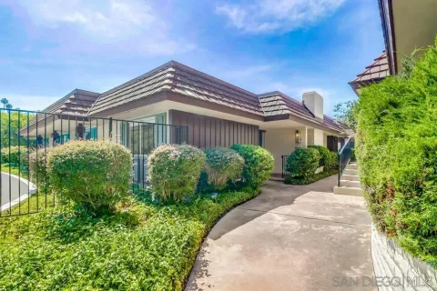 a view of a house with a small yard and plants