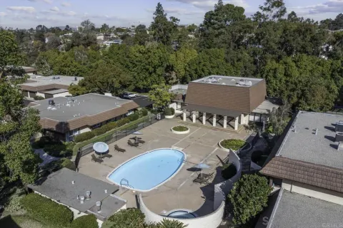 an aerial view of a house with swimming pool and outdoor seating