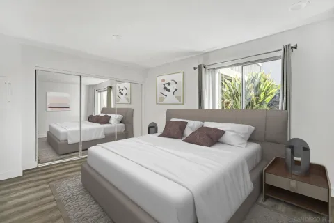 a bedroom with a bed and a large mirror