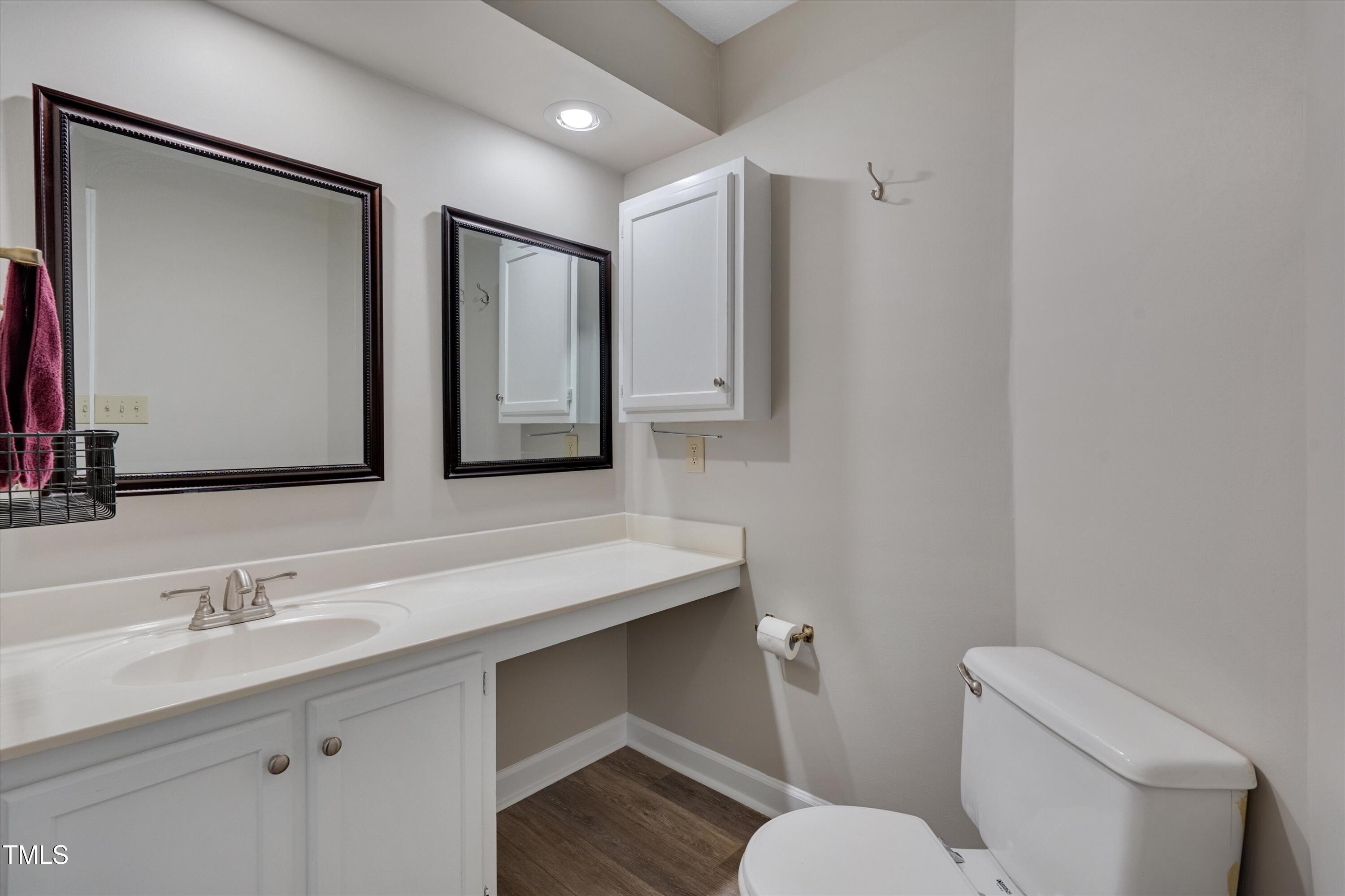 5500 Fortunes Ridge Drive, Unit 67B Durham, NC 27713 - Photo 21 of 34 a bathroom with a toilet sink and mirror