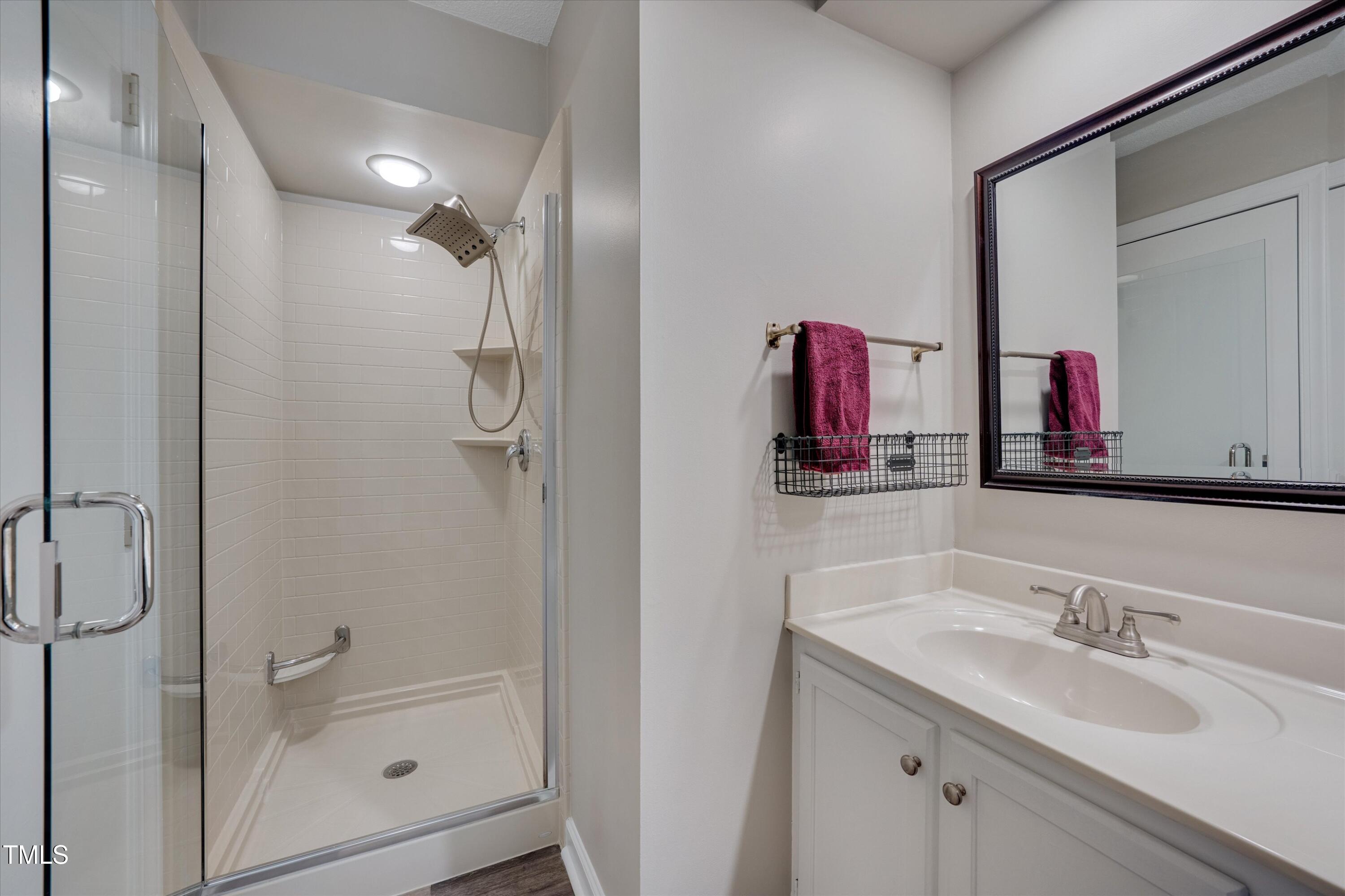 5500 Fortunes Ridge Drive, Unit 67B Durham, NC 27713 - Photo 22 of 34 a bathroom with a granite countertop sink and a mirror