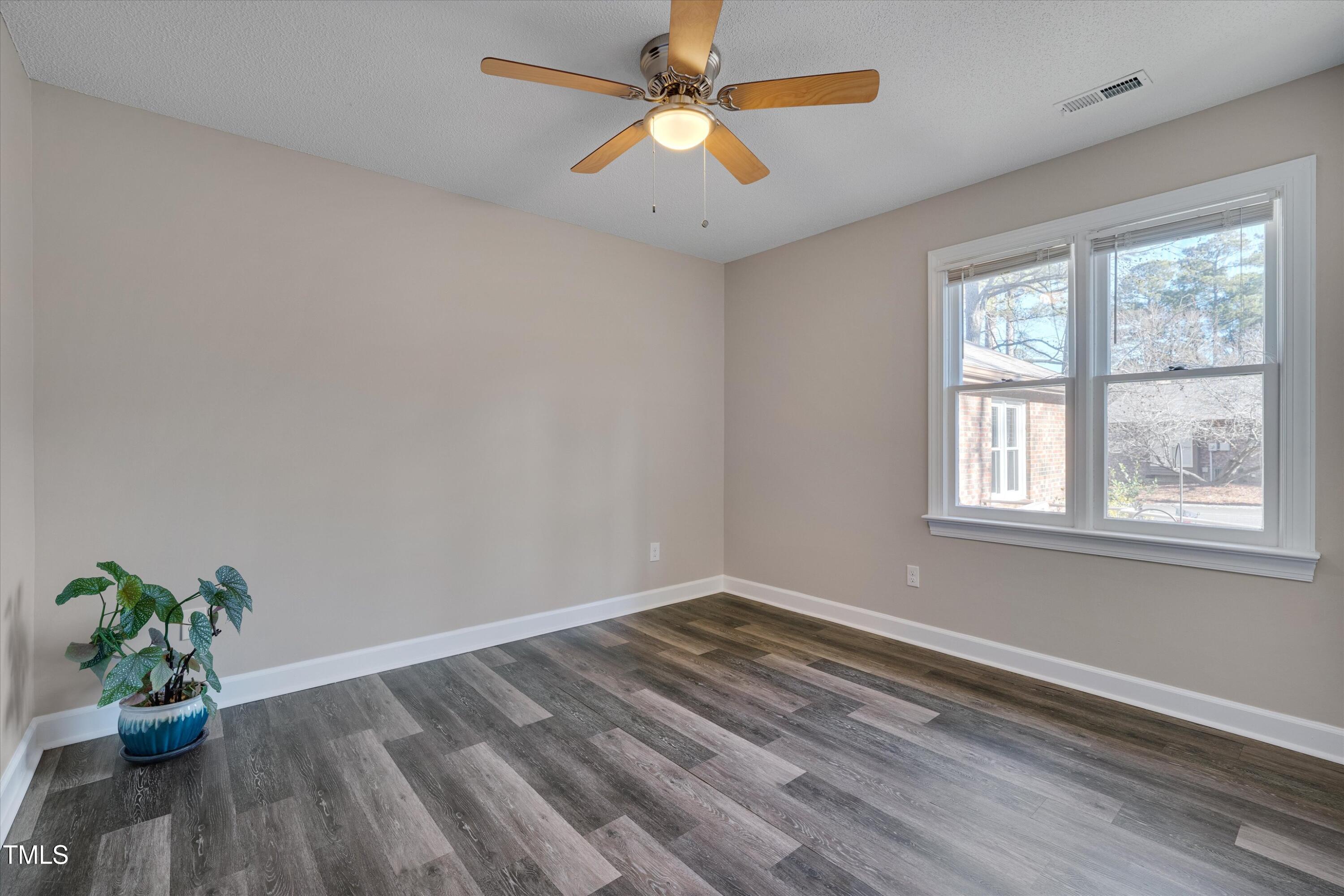 5500 Fortunes Ridge Drive, Unit 67B Durham, NC 27713 - Photo 23 of 34 a view of empty room with wooden floor and fan