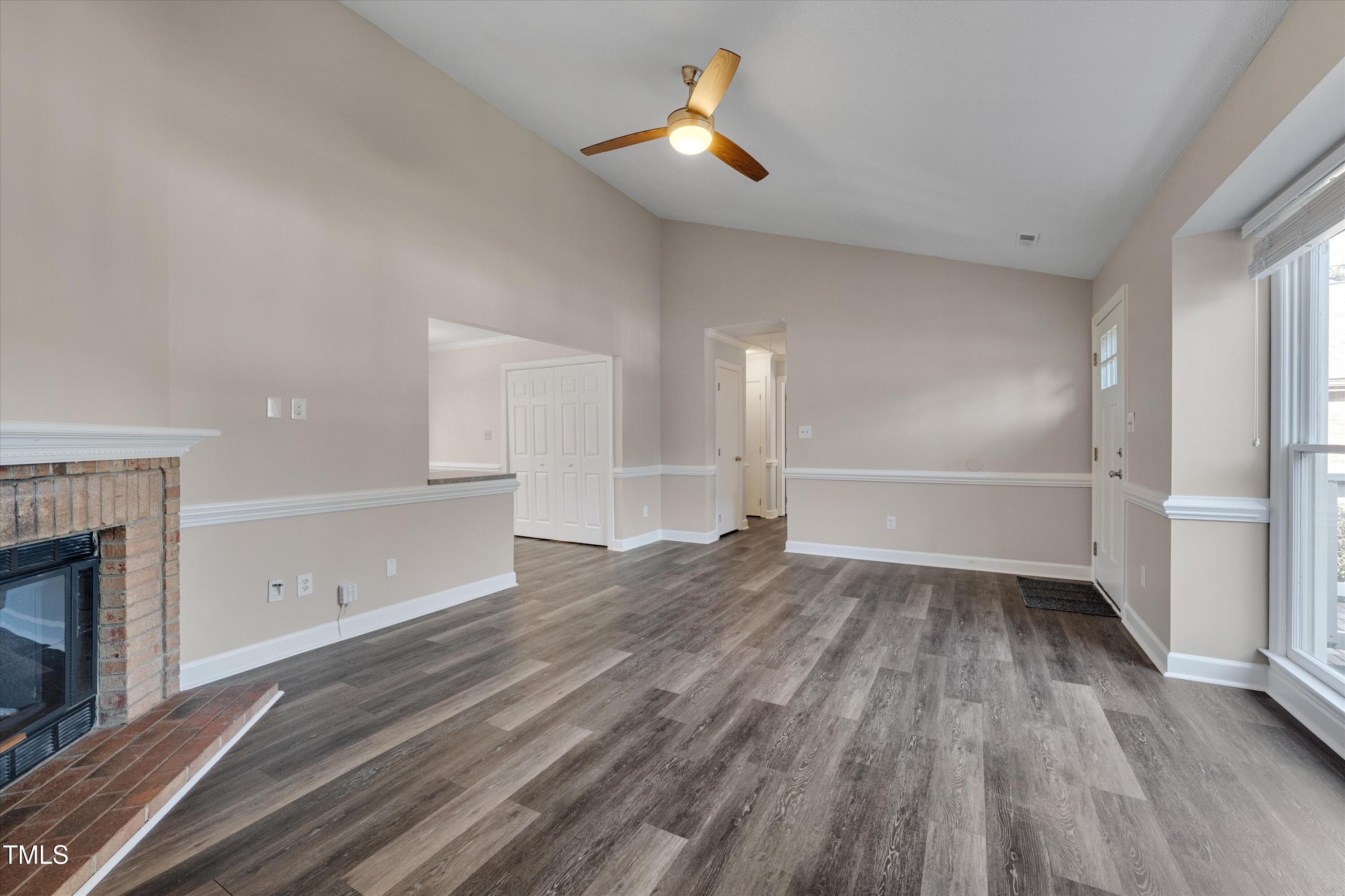 5500 Fortunes Ridge Drive, Unit 67B Durham, NC 27713 - Photo 8 of 34 an empty room with wooden floor fireplace and windows