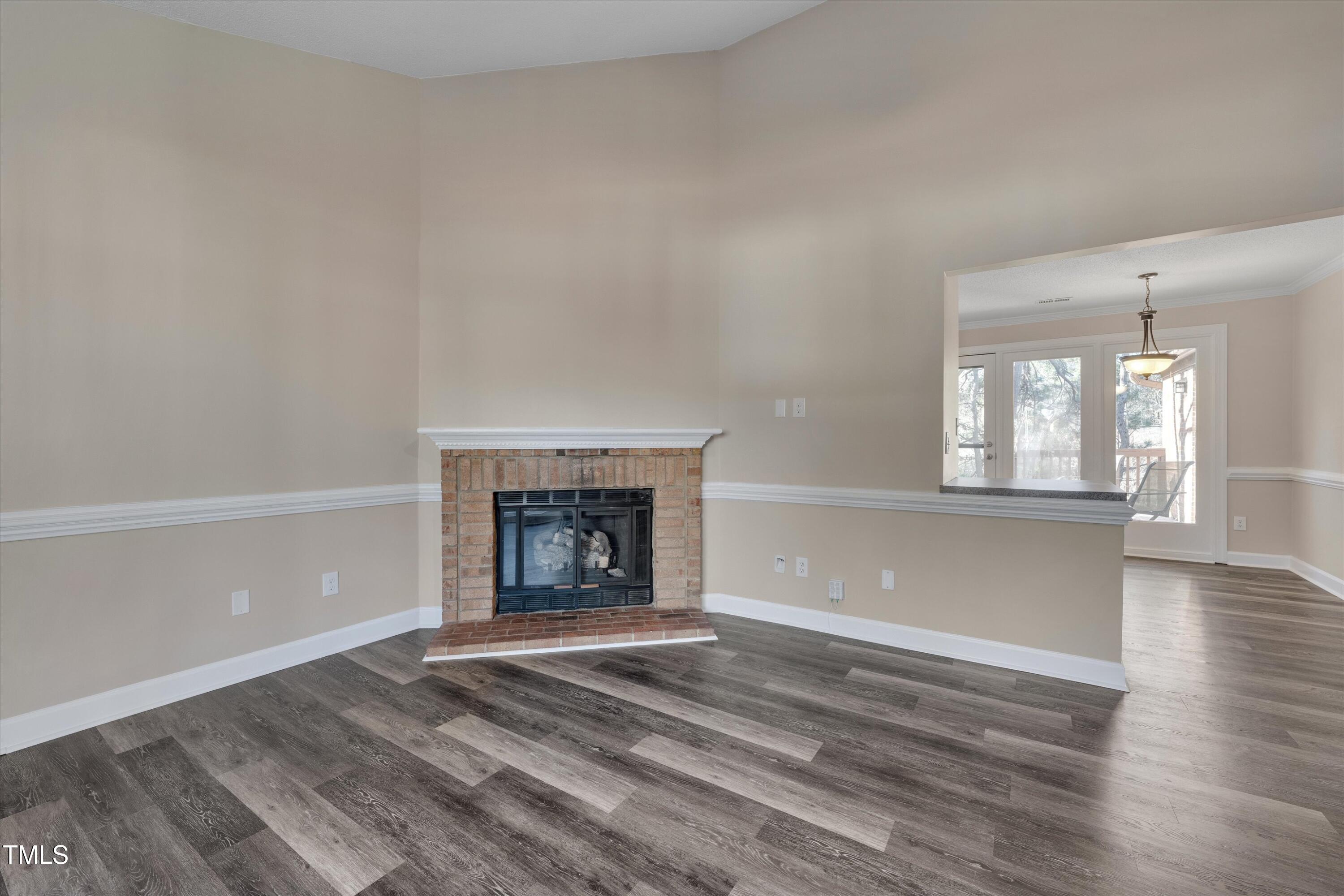 5500 Fortunes Ridge Drive, Unit 67B Durham, NC 27713 - Photo 9 of 34 an empty room with wooden floor and a window