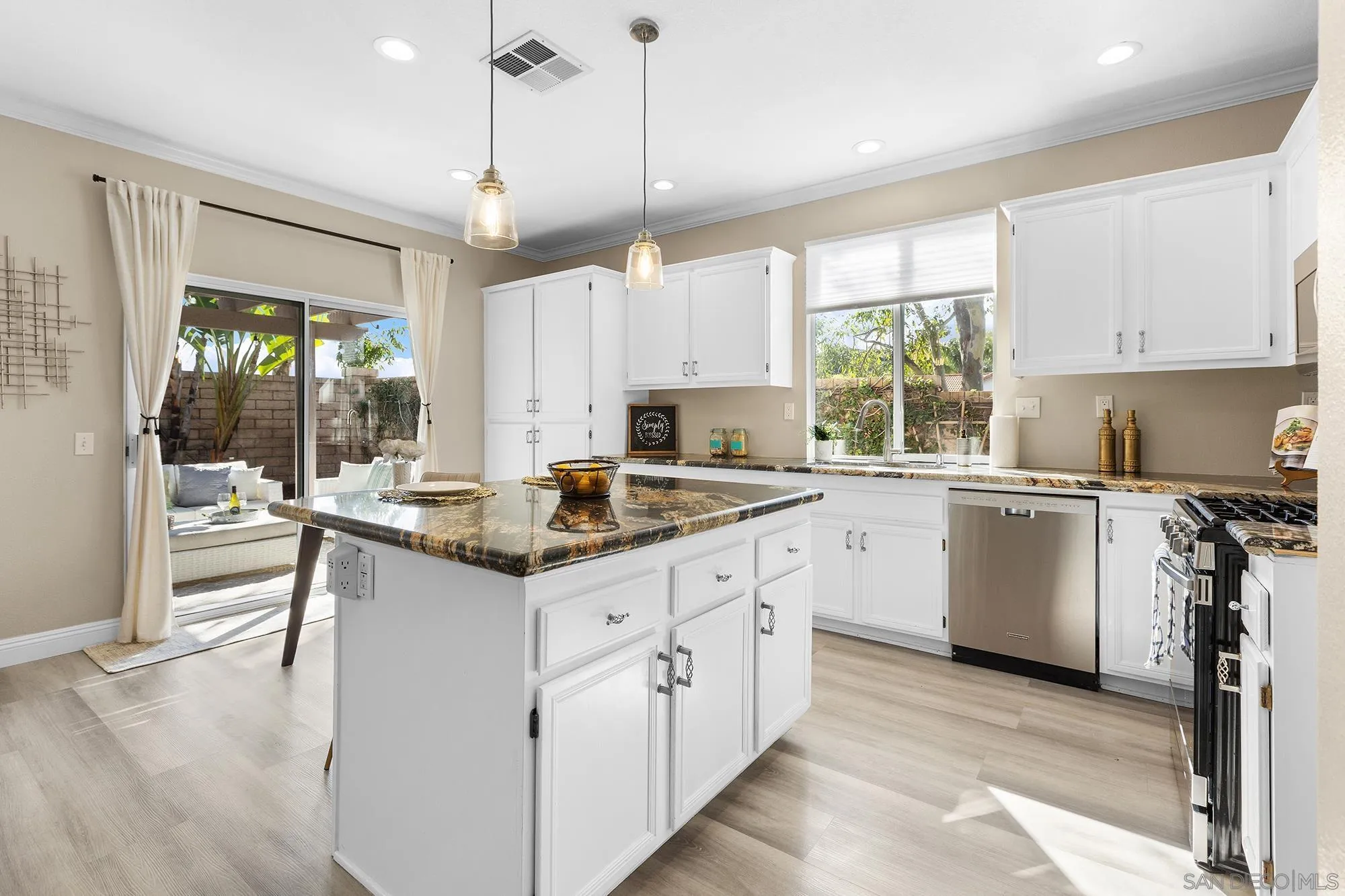 33451 Victoria Court Temecula, CA 92592 - Photo 13 of 38 a kitchen with granite countertop a sink window and cabinets