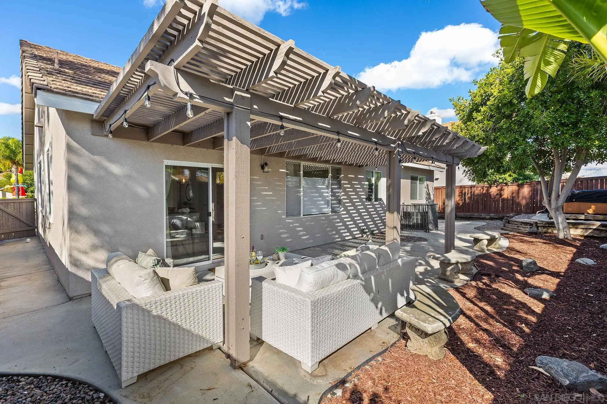 33451 Victoria Court Temecula, CA 92592 - Photo 30 of 38 a view of a patio with couches table and chairs and potted plants