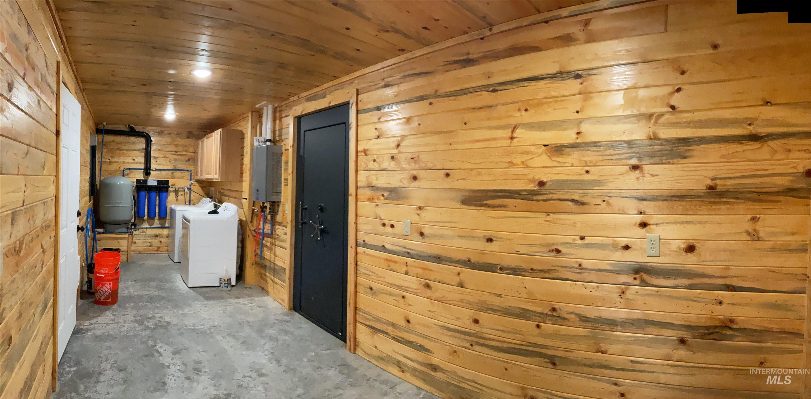 625 Rhett Creek Road Elk City, ID 83525 - Photo 47 of 48 Spacious garage featuring a concrete floor, wood-finish paneling, and an automatic garage door opener