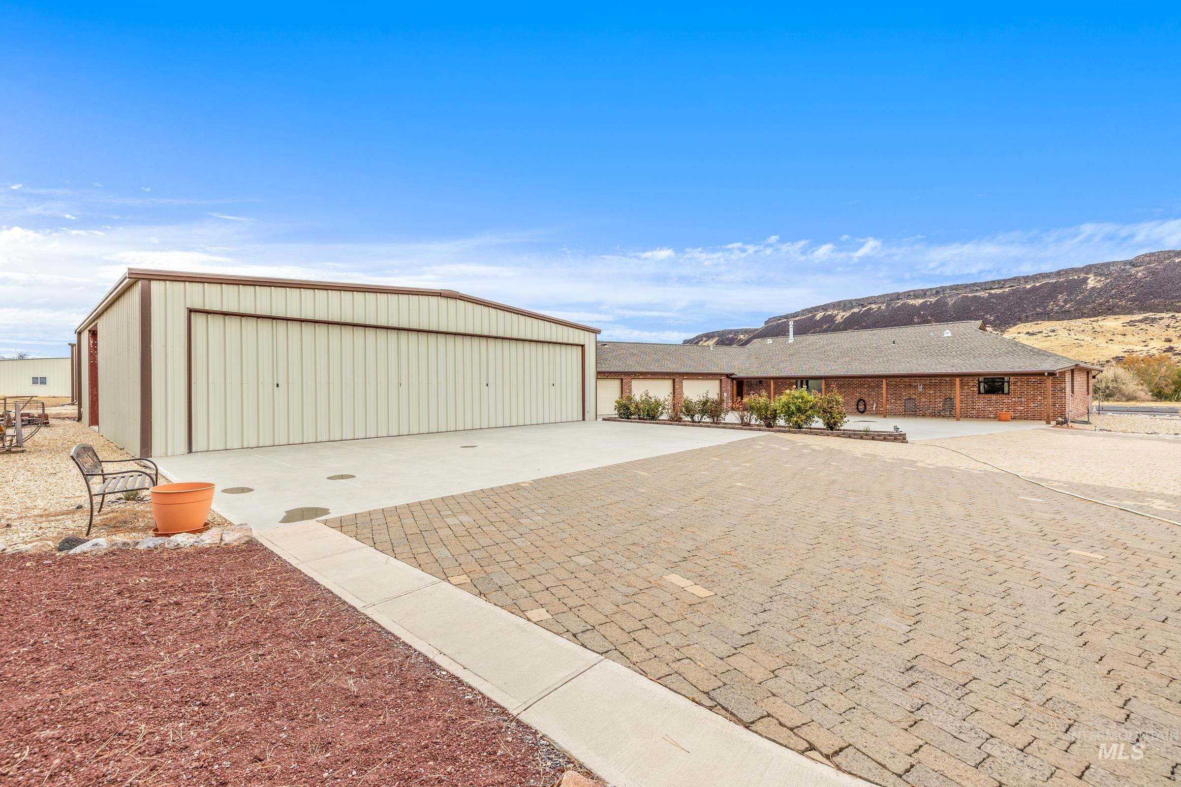10514 Airpark Loop Road Melba, ID 83641 - Photo 36 of 47 Garage featuring a mountain view and decorative driveway