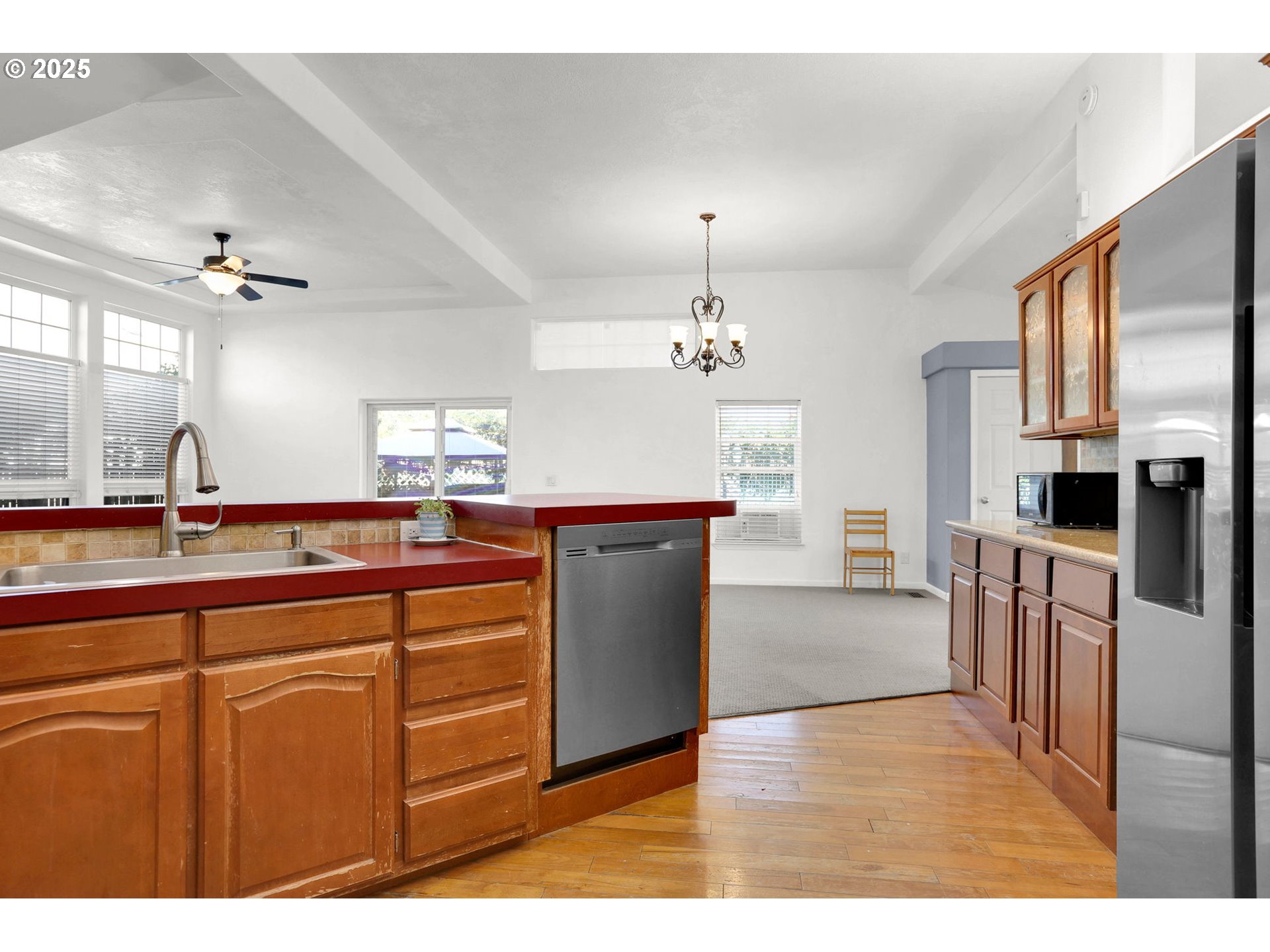 5365 Cobblestone Lane Eugene, OR 97402 - Photo 12 of 40 a kitchen with kitchen island granite countertop a sink cabinets and stainless steel appliances