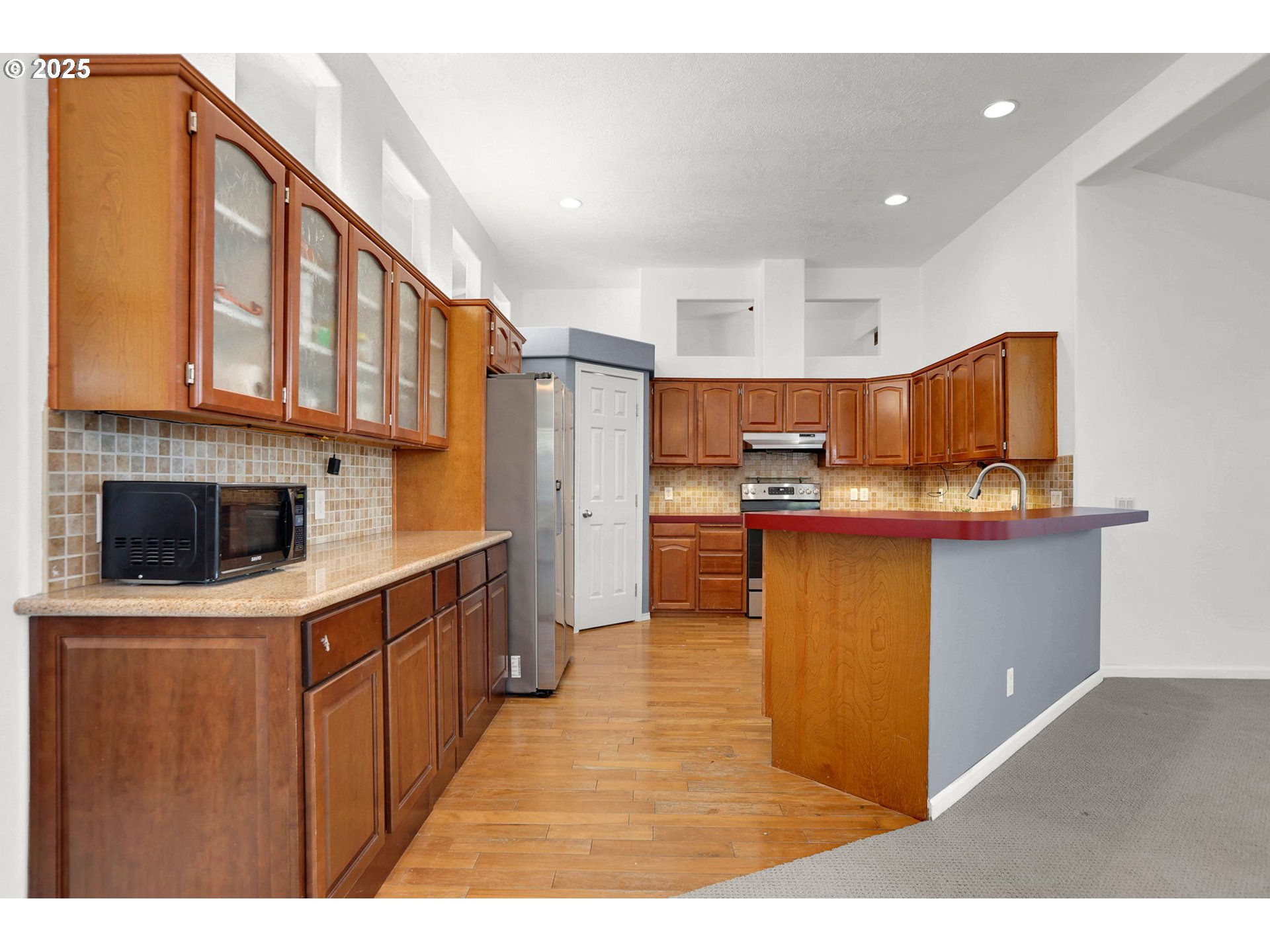 5365 Cobblestone Lane Eugene, OR 97402 - Photo 8 of 40 a kitchen with stainless steel appliances kitchen island granite countertop a sink and cabinets