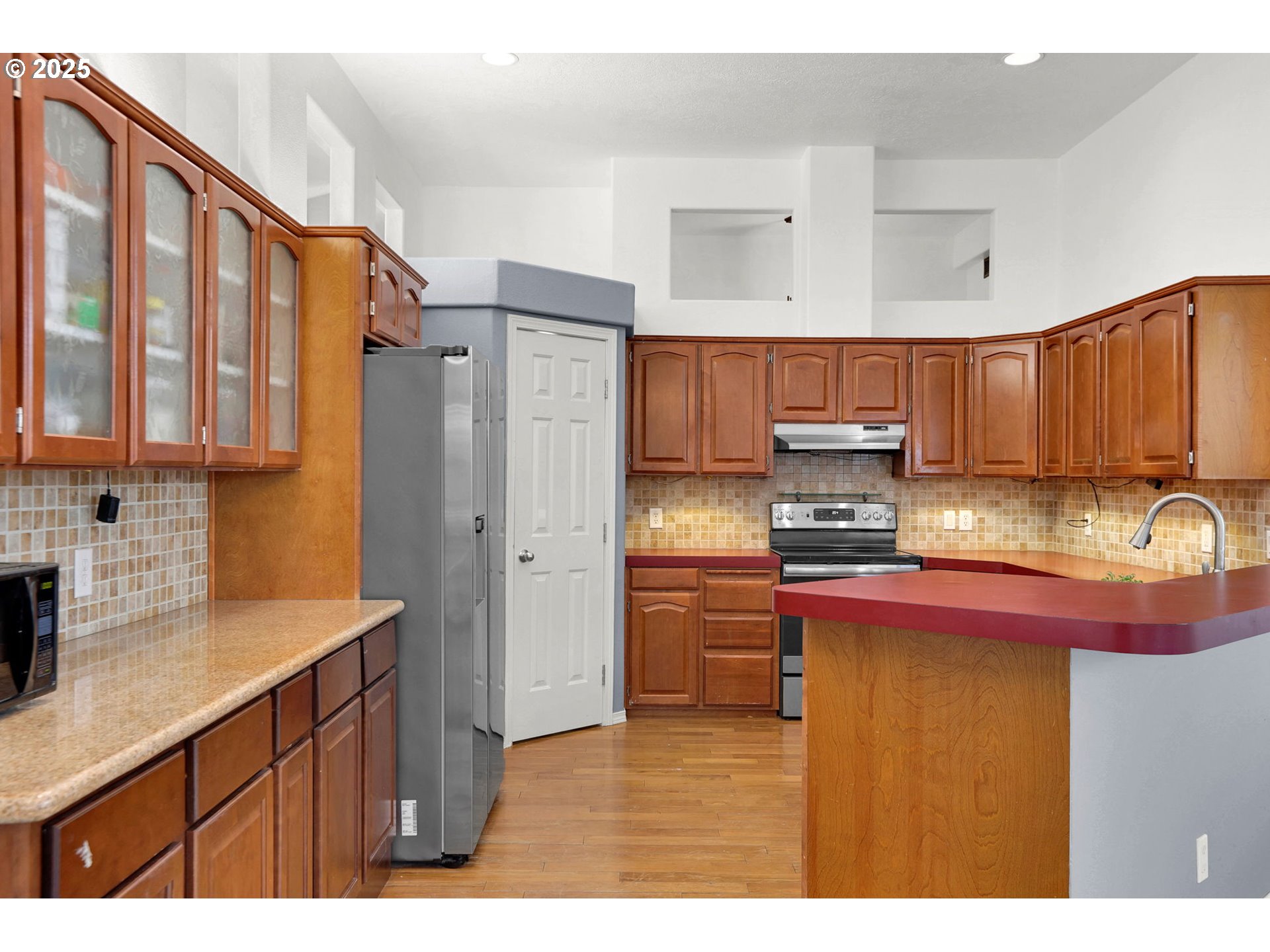 5365 Cobblestone Lane Eugene, OR 97402 - Photo 9 of 40 a kitchen with stainless steel appliances granite countertop a refrigerator a sink dishwasher a stove with wooden cabinets