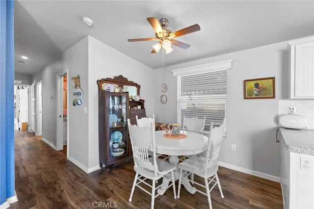 a kitchen with white cabinets and appliances
