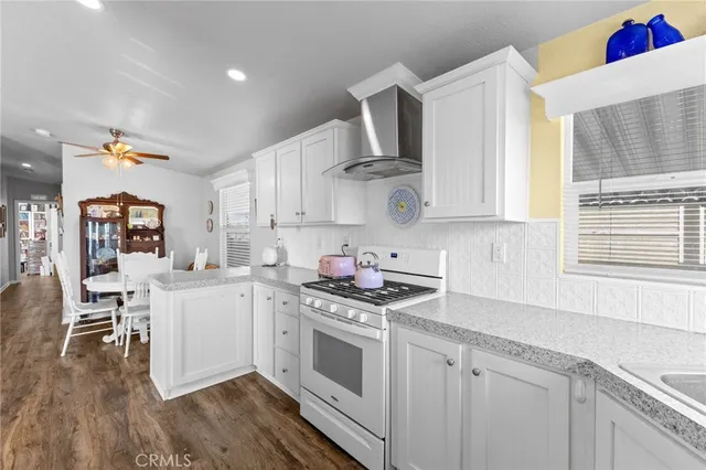 a kitchen with granite countertop a stove and cabinets