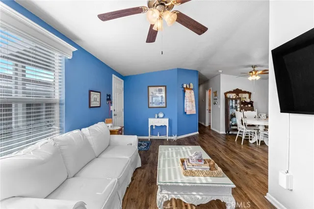 a living room with furniture a rug and a flat screen tv