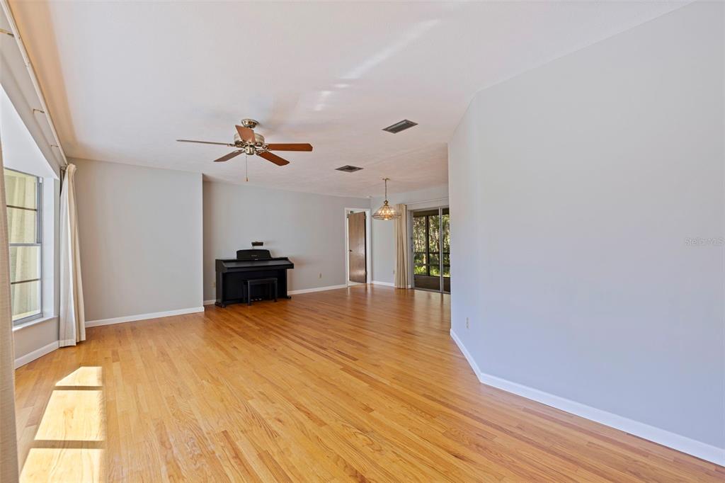 8609 Stoner Road Riverview, FL 33569 - Photo 14 of 66 a view of empty room with wooden floor and fan