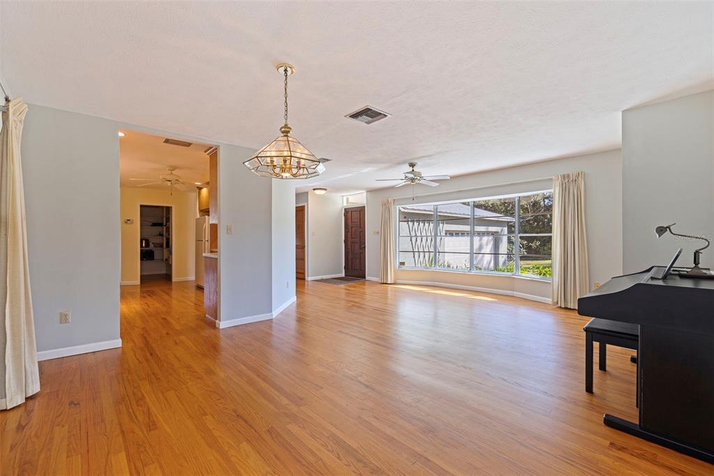 8609 Stoner Road Riverview, FL 33569 - Photo 16 of 66 a view of an empty room with wooden floor and a window