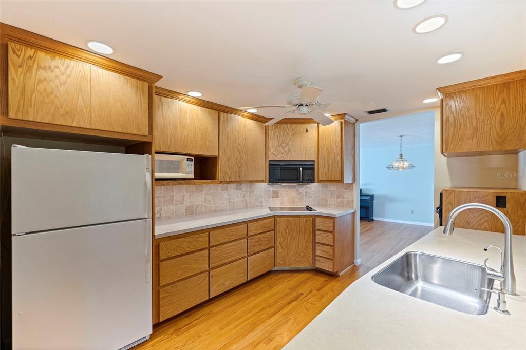 8609 Stoner Road Riverview, FL 33569 - Photo 19 of 66 a kitchen with stainless steel appliances granite countertop a sink and a refrigerator