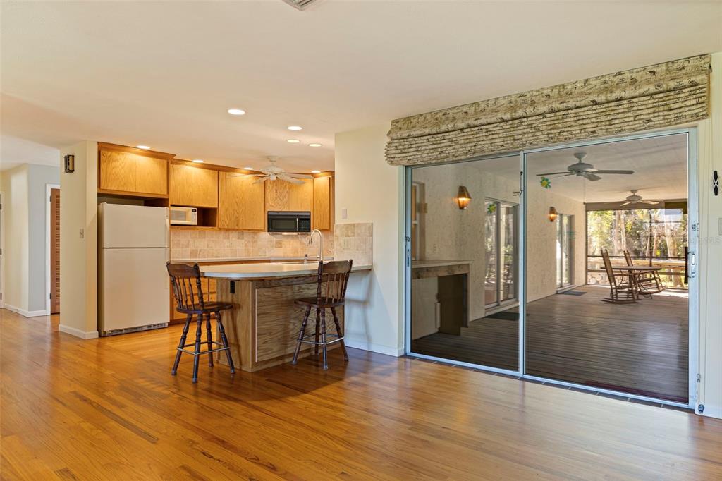 8609 Stoner Road Riverview, FL 33569 - Photo 21 of 66 a kitchen with stainless steel appliances kitchen island granite countertop dining table chairs and granite counter tops