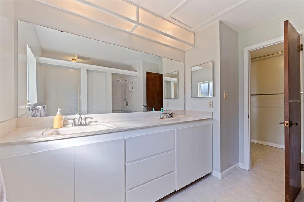 8609 Stoner Road Riverview, FL 33569 - Photo 27 of 66 a bathroom with a double vanity sink and mirror